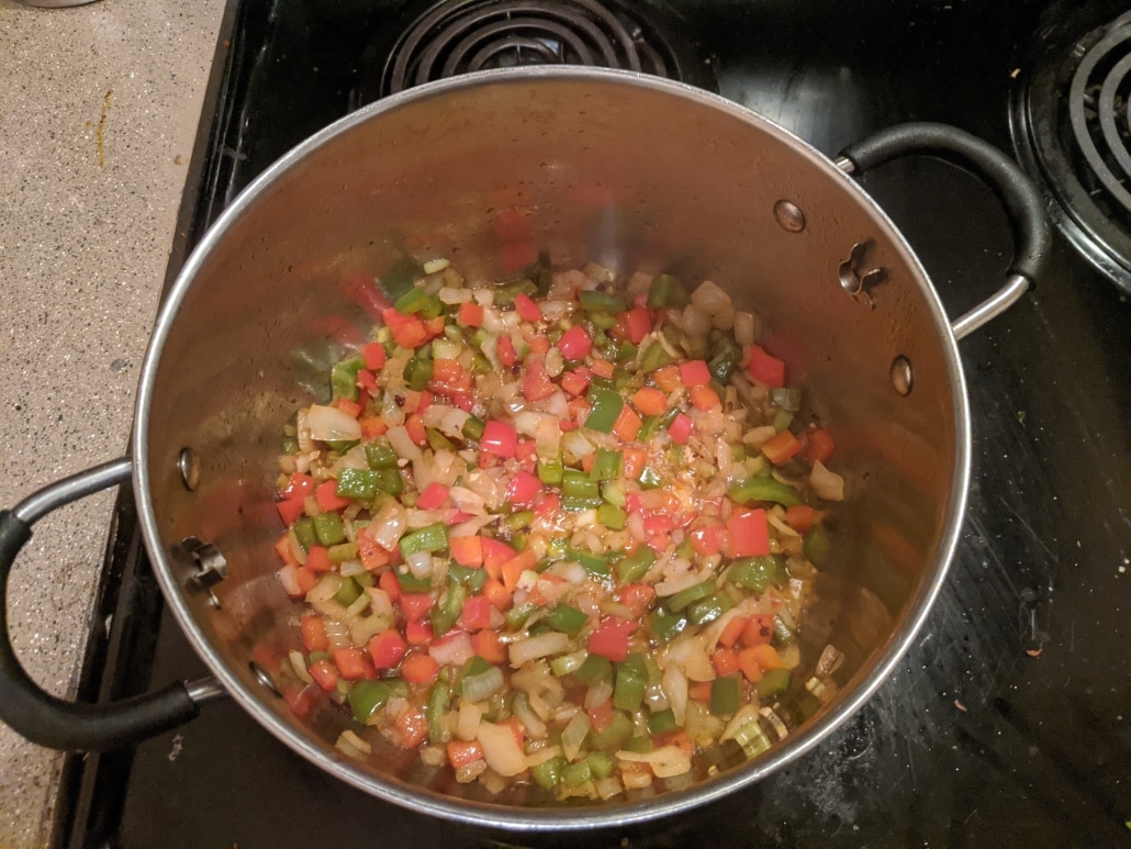 Cooked onions, celery, bell peppers, and garlic. These ingredients are critical to the flavors of our jambalaya.