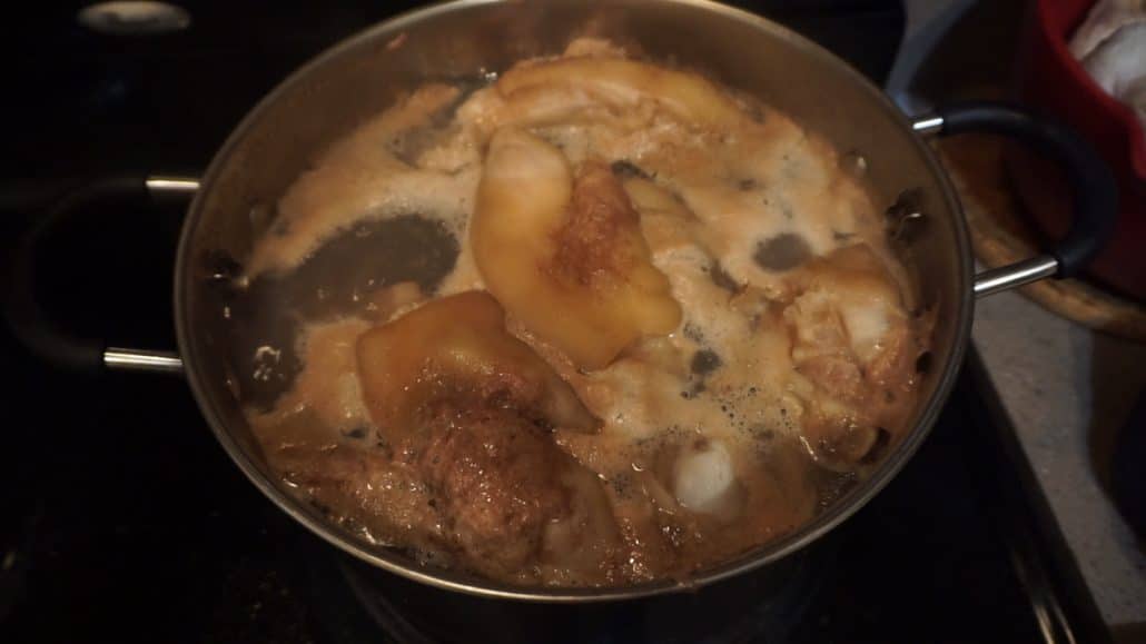 Scum forming on boiling pork bones