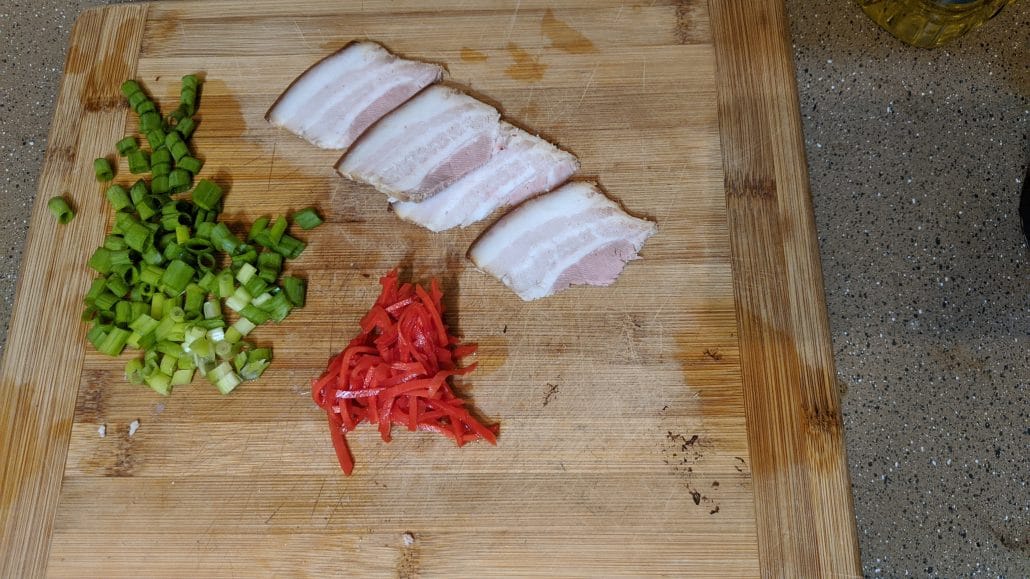Sliced green onion, chashu pork belly slices, and pickled ginger, also called beni shoga