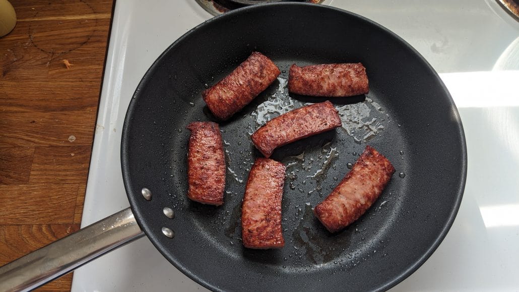 Cooked andouille sausage in a skillet