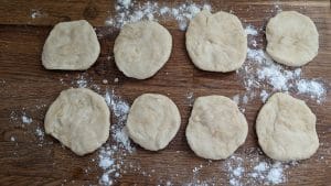 8 portions of tortilla dough, flattened