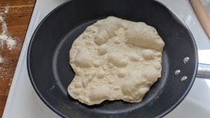 A cooking tortilla, done on one side