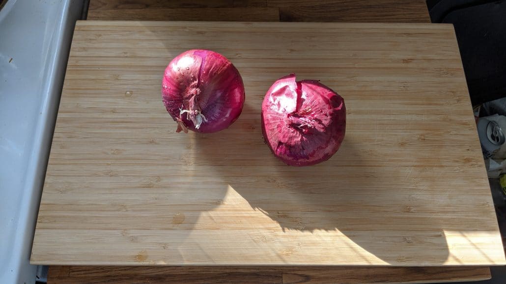 2 red onions on a cutting board