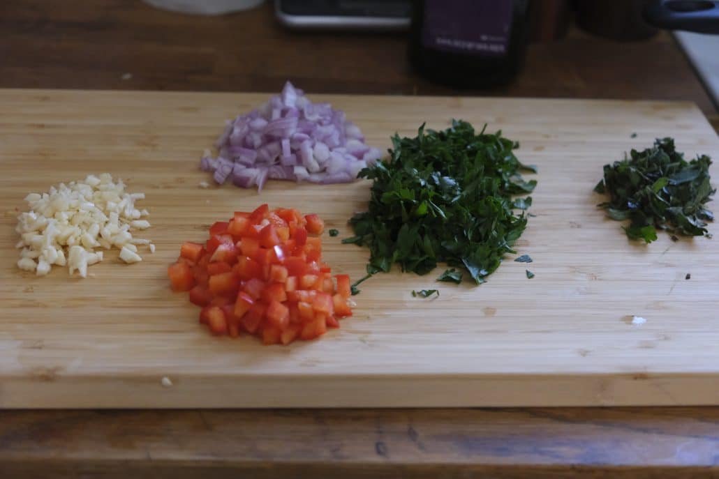 Chopped parsley, oregano, shallot, garlic, and red bell pepper.