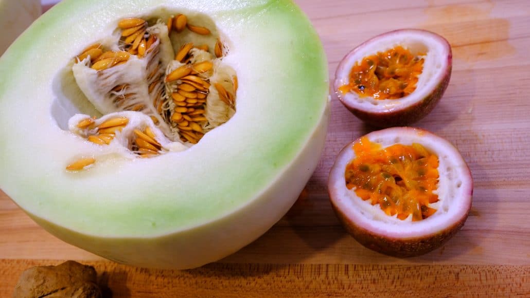 Honeydew and a passion fruit, both cut in half.